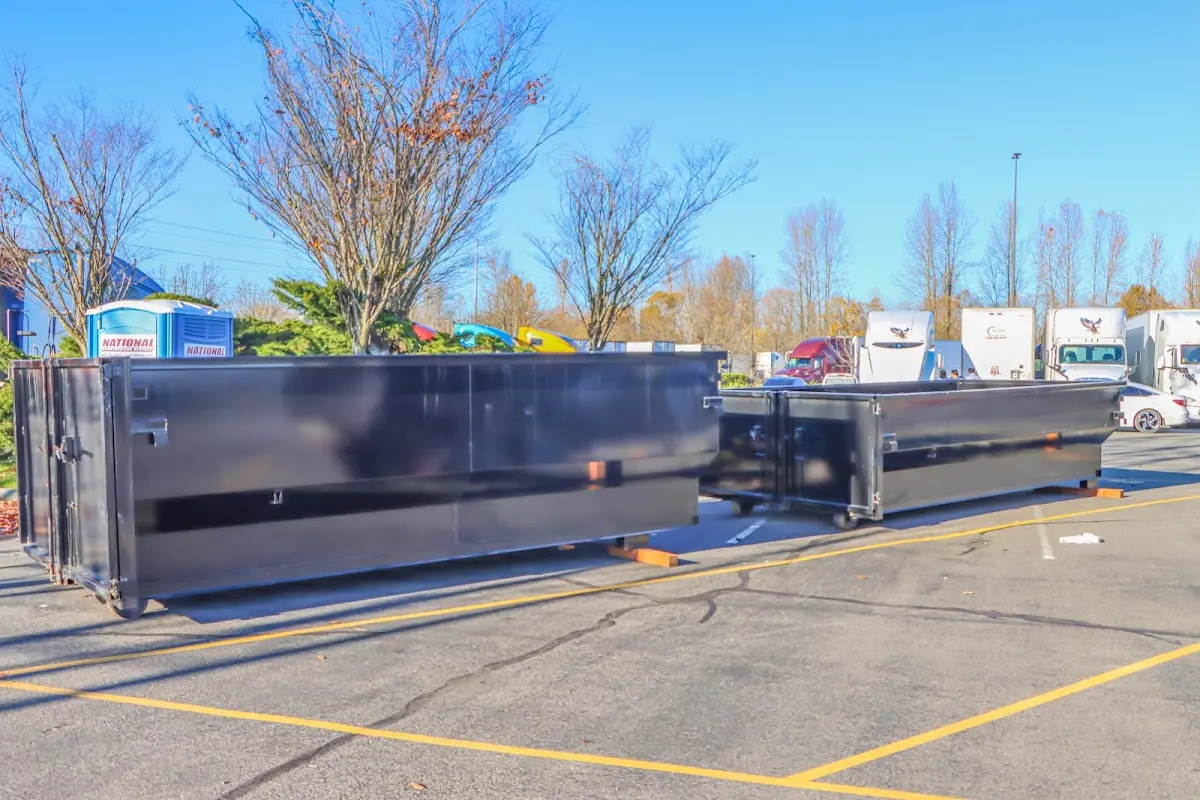 Professional dumpster rental service with roll-off container on residential driveway in Coalinga